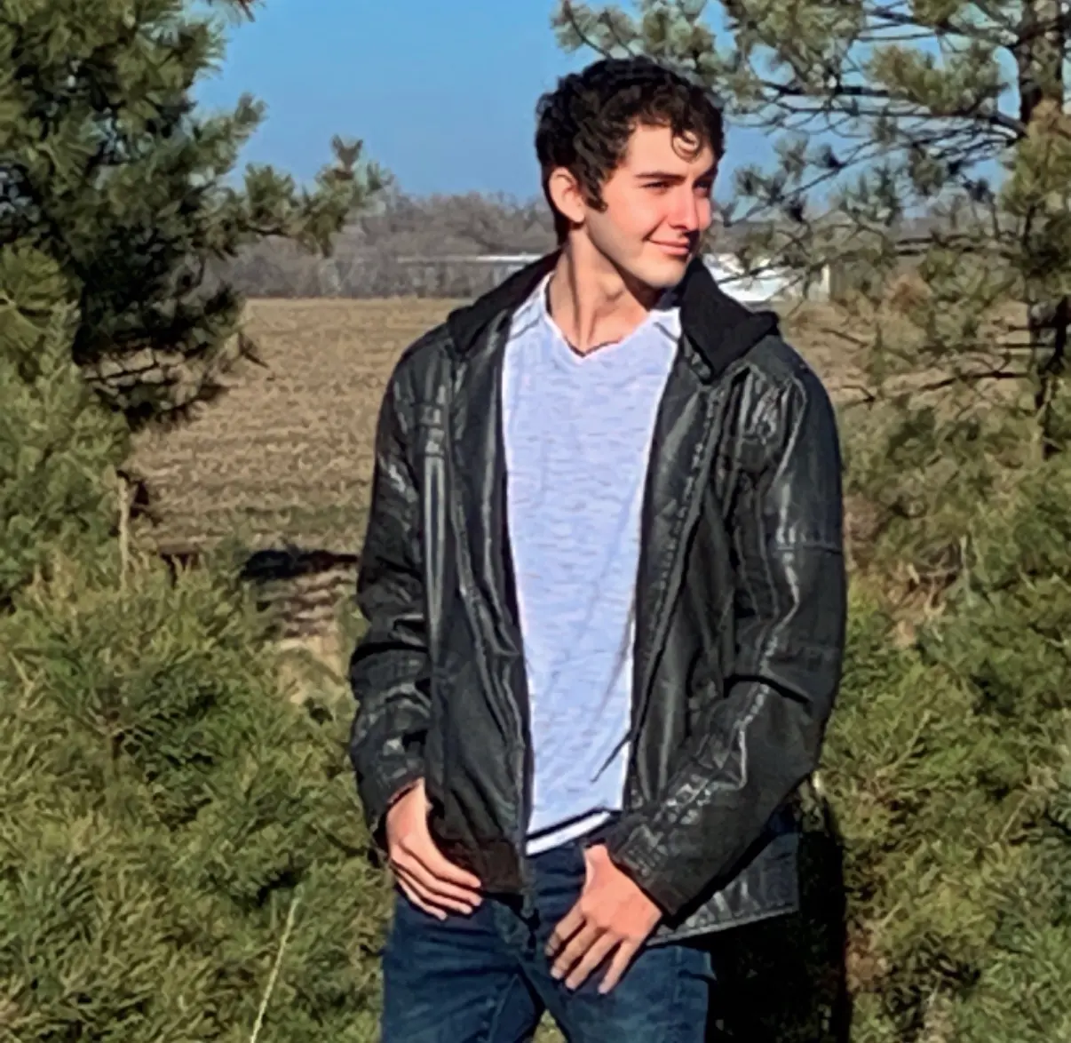 Ethan standing outdoors in a leather jacket